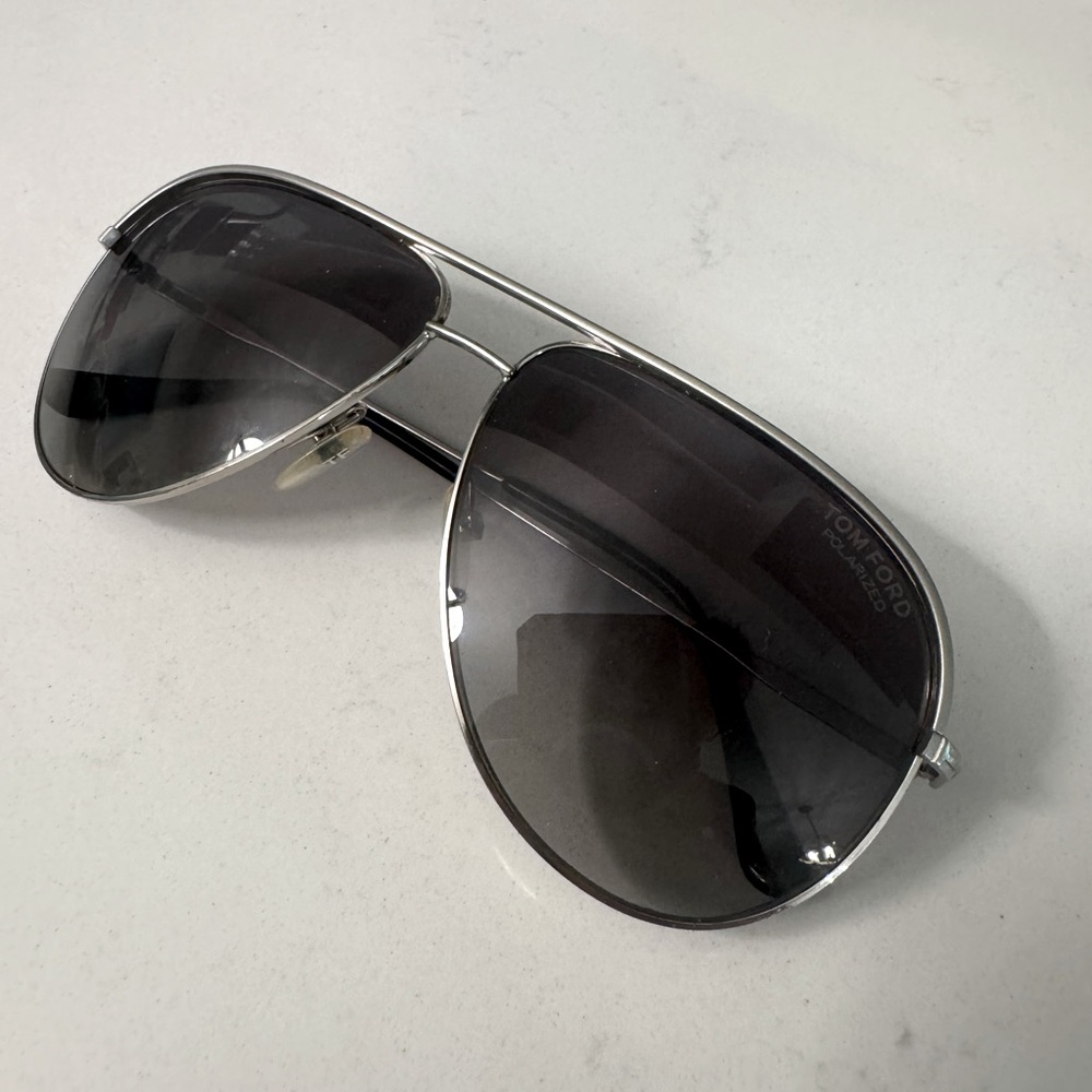 Tom Ford polarized sunglasses, black tinted lenses and silver rims.